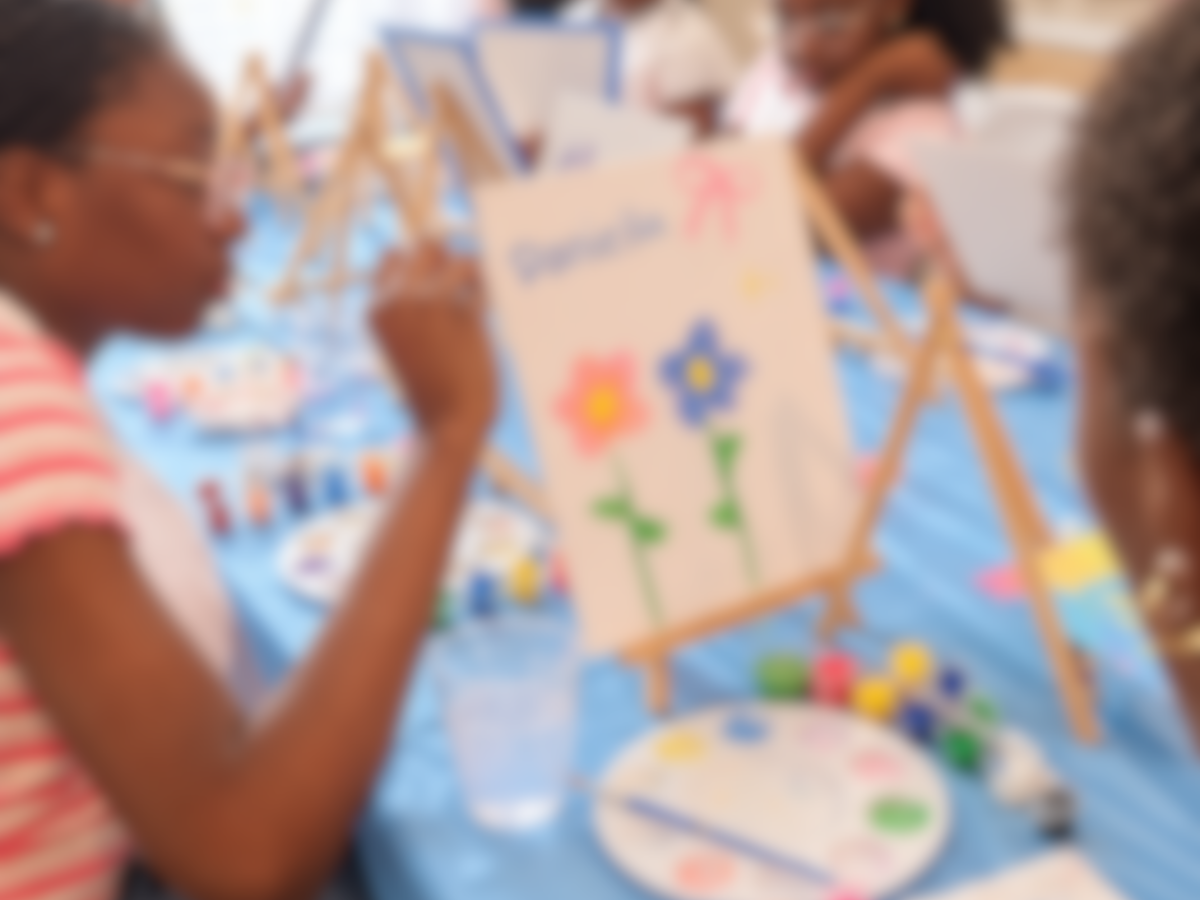 Kids painting flower canvases at a birthday party