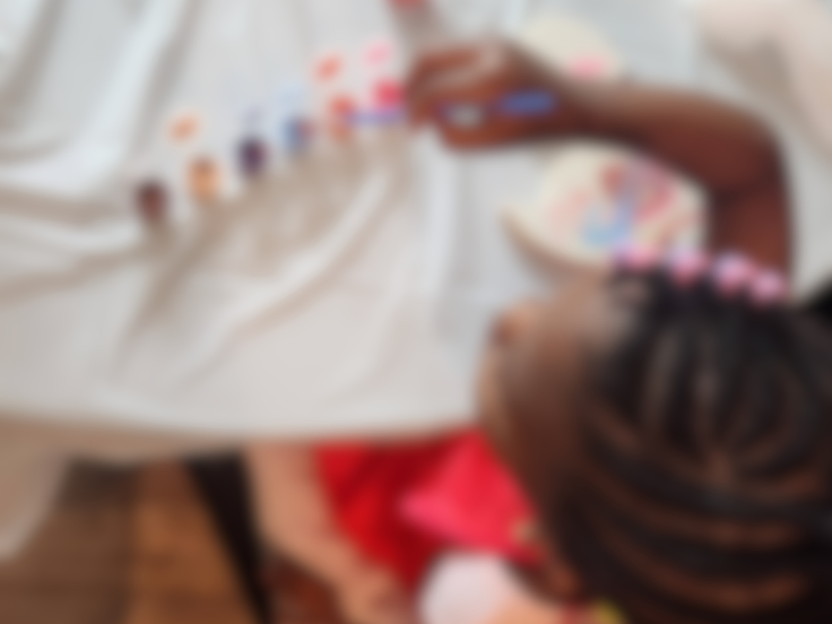 A little one painting a ceramic piece at a celebration